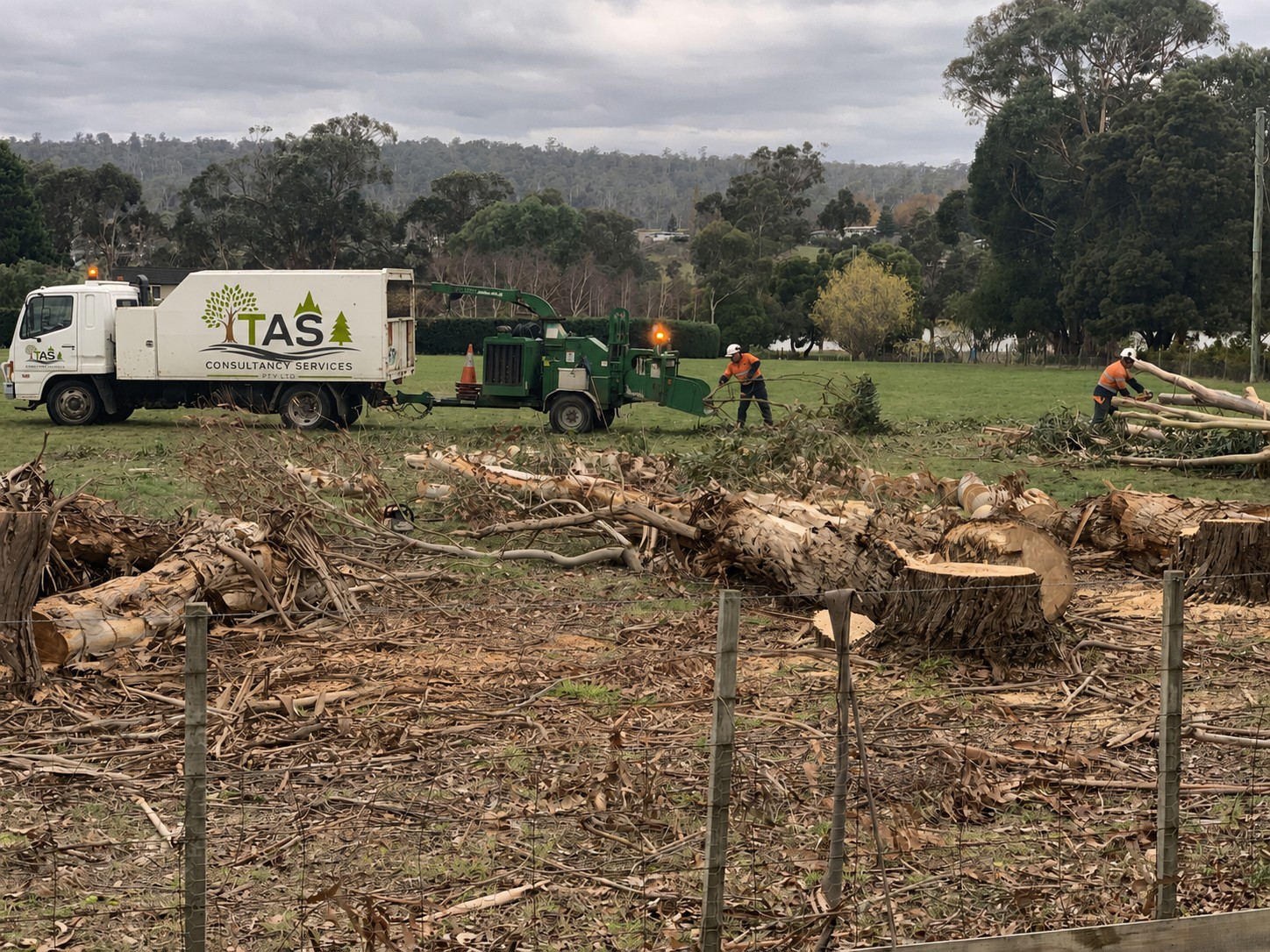 TAS Consulting Services crew clearing a residential site with chipper and truck